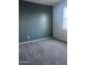 Bedroom features neutral carpet, gray accent wall, and a window with blinds for natural light at 29906 W Whitton Ave, Buckeye, AZ 85396
