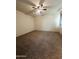 Inviting bedroom featuring plush carpeting, and a modern ceiling fan at 29906 W Whitton Ave, Buckeye, AZ 85396