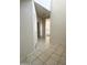 Neutral tiled hallway view leading toward an open floorplan with natural light at 29906 W Whitton Ave, Buckeye, AZ 85396