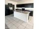 Kitchen featuring granite countertops and modern dark cabinets with neutral tiled flooring at 29906 W Whitton Ave, Buckeye, AZ 85396