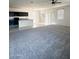 Open floor plan between the kitchen and living room with carpet and neutral tiles at 29906 W Whitton Ave, Buckeye, AZ 85396