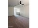 Open living room featuring plush carpeting, neutral paint, and contemporary ceiling fan at 29906 W Whitton Ave, Buckeye, AZ 85396