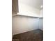 Expansive walk-in closet with carpeted floors, shelving, and rods for efficient organization at 29906 W Whitton Ave, Buckeye, AZ 85396