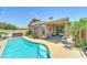 Backyard oasis featuring a pool, jacuzzi, and covered patio at 3128 W Belle Ave, San Tan Valley, AZ 85144