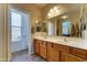 Bathroom features double sinks, wood cabinets, and a large mirror providing ample space at 3128 W Belle Ave, San Tan Valley, AZ 85144