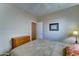 Comfortable bedroom with neutral walls, a dresser, and convenient access to a doorway at 3128 W Belle Ave, San Tan Valley, AZ 85144