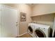 Laundry room with a set of white washer and dryer units at 3128 W Belle Ave, San Tan Valley, AZ 85144