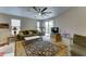 Cozy living room featuring a ceiling fan, comfortable seating, and sliding door access to the outdoors at 3128 W Belle Ave, San Tan Valley, AZ 85144