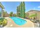 Backyard pool surrounded by lush greenery and a row of tall trees at 3128 W Belle Ave, San Tan Valley, AZ 85144