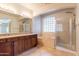 Bright bathroom featuring double sinks, cabinets, soaking tub, and walk-in shower at 3173 E Canyon Way, Chandler, AZ 85249