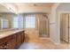 Bright bathroom featuring double sinks, cabinets, soaking tub, and walk-in shower at 3173 E Canyon Way, Chandler, AZ 85249