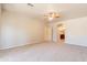 Spacious bedroom featuring neutral carpet, ceiling fan, and ensuite bathroom access at 3173 E Canyon Way, Chandler, AZ 85249