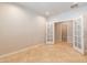 A versatile room with an open doorway, tile flooring and a pair of doors leading to another area at 3173 E Canyon Way, Chandler, AZ 85249