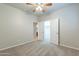 Bedroom featuring neutral carpeting and access to closet and bathroom at 3173 E Canyon Way, Chandler, AZ 85249