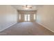 Open bedroom with neutral carpet, ceiling fan, and natural light at 3173 E Canyon Way, Chandler, AZ 85249