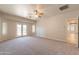 Bright bedroom showcasing neutral carpet, ceiling fan, and outdoor access at 3173 E Canyon Way, Chandler, AZ 85249