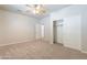 Bedroom with neutral carpeting, closet, and bathroom doorway at 3173 E Canyon Way, Chandler, AZ 85249