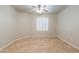 Clean bedroom with window, ceiling fan, and tile flooring at 3173 E Canyon Way, Chandler, AZ 85249