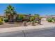 Charming single-Gathering home featuring a manicured front yard, mature palm trees, and a two-car garage at 3173 E Canyon Way, Chandler, AZ 85249
