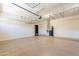 Well lit garage with installed shelving, epoxy floors, and a water heater closet at 3173 E Canyon Way, Chandler, AZ 85249