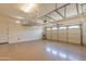 Spacious garage with installed shelving and an automatic garage door opener at 3173 E Canyon Way, Chandler, AZ 85249
