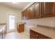 Spacious laundry room with sink, countertop, and ample cabinet storage at 3173 E Canyon Way, Chandler, AZ 85249