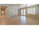 Open-concept living area features tile flooring, a ceiling fan, and access to the outside with double doors at 3173 E Canyon Way, Chandler, AZ 85249