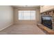 Comfortable living room featuring neutral carpet and a stylish stone fireplace at 3173 E Canyon Way, Chandler, AZ 85249