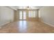 Bright living room with tile flooring, double doors, plantation shutters and a ceiling fan at 3173 E Canyon Way, Chandler, AZ 85249