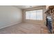 Comfortable living room with neutral carpet and a charming stone fireplace at 3173 E Canyon Way, Chandler, AZ 85249