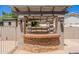 Outdoor kitchen featuring stone accents, a bar, and a pergola at 3173 E Canyon Way, Chandler, AZ 85249