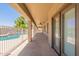 Spacious covered patio with stone flooring and a view of the backyard pool at 3173 E Canyon Way, Chandler, AZ 85249