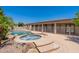 Backyard pool and hot tub area with desert landscaping and covered patio view at 3173 E Canyon Way, Chandler, AZ 85249