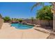 Private backyard featuring a large swimming pool with a rock waterfall feature at 3173 E Canyon Way, Chandler, AZ 85249