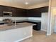 Modern kitchen with granite countertops, stainless steel appliances, and dark wood cabinets at 31774 N Bandit Rd, San Tan Valley, AZ 85143