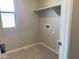 A bright laundry room features tile flooring and a utility sink hook-up at 31774 N Bandit Rd, San Tan Valley, AZ 85143