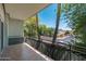 This balcony view features tall palm trees, lush landscaping, and a neighborhood street at 330 W Maryland Ave # 207, Phoenix, AZ 85013