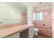 Bathroom featuring pink tile and countertop, sink, and bathtub/shower combo at 330 W Maryland Ave # 207, Phoenix, AZ 85013