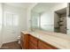 Bathroom with large mirror, wooden vanity and countertop, toilet, and shower at 330 W Maryland Ave # 207, Phoenix, AZ 85013