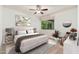 Bright bedroom featuring neutral tones, ceiling fan, and large window with natural light at 330 W Maryland Ave # 207, Phoenix, AZ 85013