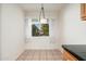 The dining area features a light fixture and large window with natural light at 330 W Maryland Ave # 207, Phoenix, AZ 85013