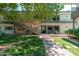 Charming two-story condo with stone accents, stairs to the second level, and lush landscaping at 330 W Maryland Ave # 207, Phoenix, AZ 85013