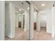 Hallway features mirrored closet doors leading to two bathrooms with wooden vanities at 330 W Maryland Ave # 207, Phoenix, AZ 85013