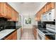 Galley kitchen featuring wood cabinetry and plenty of counter space at 330 W Maryland Ave # 207, Phoenix, AZ 85013