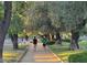 A tree-lined path with joggers creates a picturesque scene with a serene and active atmosphere at 330 W Maryland Ave # 207, Phoenix, AZ 85013