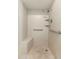 Modern shower with white tile, built-in bench, and accessible grab bars at 330 W Maryland Ave # 207, Phoenix, AZ 85013