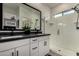 Modern bathroom features a double vanity with dark countertop and a glass enclosed shower at 4548 S Renaissance Dr # 103, Gilbert, AZ 85297