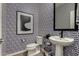 Stylish powder room with patterned wallpaper, modern fixtures, and a pedestal sink at 4548 S Renaissance Dr # 103, Gilbert, AZ 85297