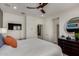 Spacious bedroom with a white bed, dresser, television and large windows at 4548 S Renaissance Dr # 103, Gilbert, AZ 85297