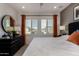 Bedroom featuring neutral colored walls, plantation shutters and dresser at 4548 S Renaissance Dr # 103, Gilbert, AZ 85297